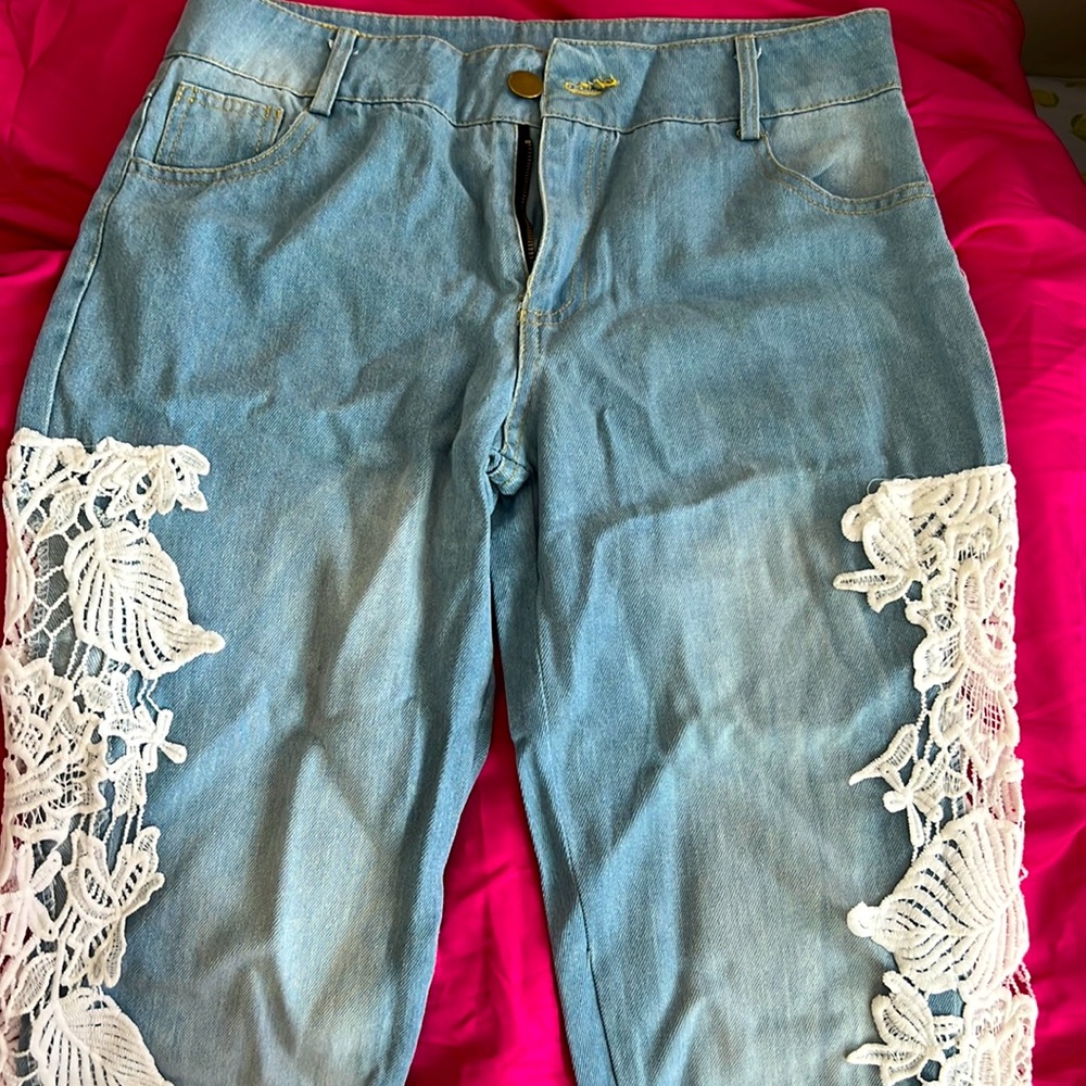 Light blue jeans with white lace on side